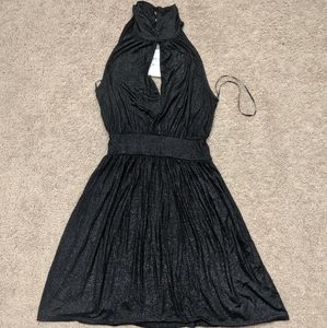 Black dress with shimmer buckles at neck.